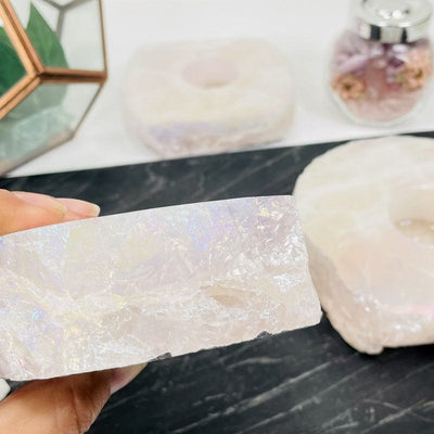 side shot of the angel aura coated rose quartz candle holder showing the thickness of the stone 