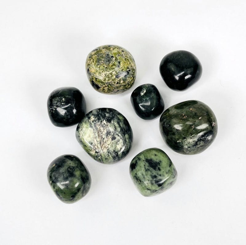 1/2 LB of nephrite tumbled stones on white background 