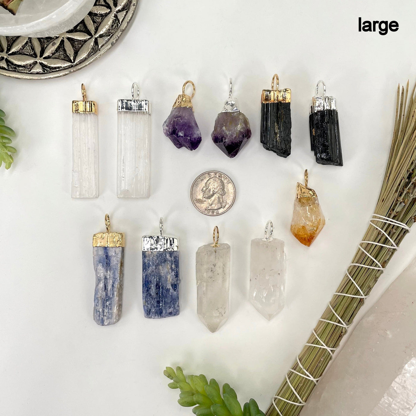 all large gemstone point pendants on white background with quarter for size reference