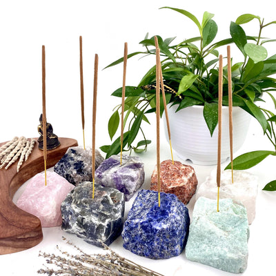 8 Rough Stone Incense Burners of different crystals with decorations in the background