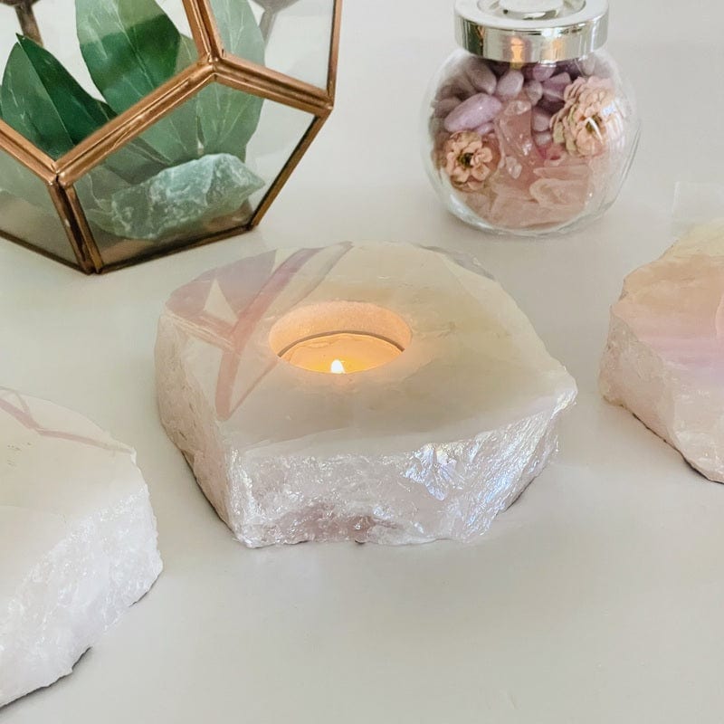 side shot of the angel aura coated rose quartz candle holder showing the thickness of the stone candle 