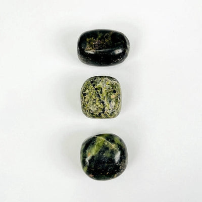 nephrite tumbled stones showing the different possible color shades and patterns