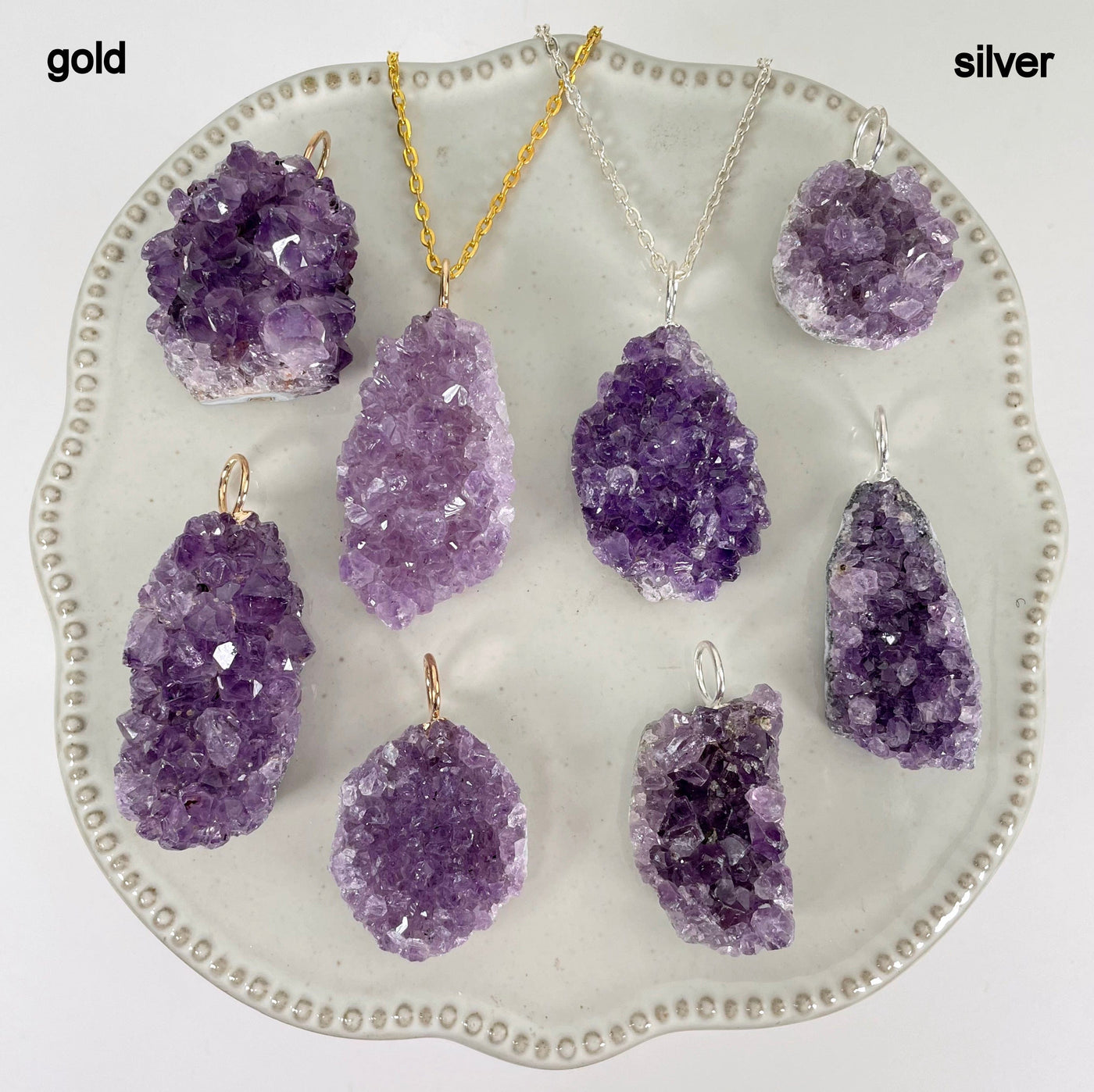 gold and silver amethyst druzy cluster pendants on display for finish comparison 