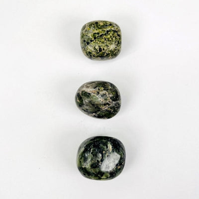 nephrite tumbled stones showing the different possible color shades and patterns