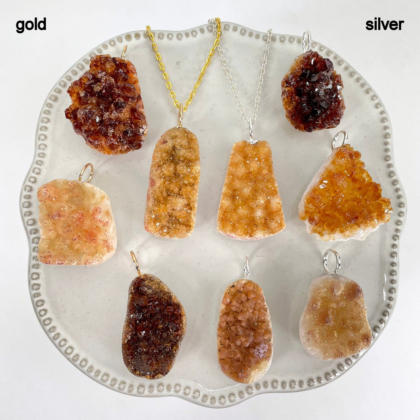 gold and silver golden amethyst druzy cluster pendants on display for finish comparison