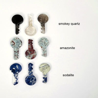 multiple smokey quartz, amazonite and sodalite gemstone keys showing the differences  