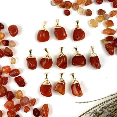 11 Tumbled Carnelian Pendant with Electroplated 24k Gold Caps  on white background