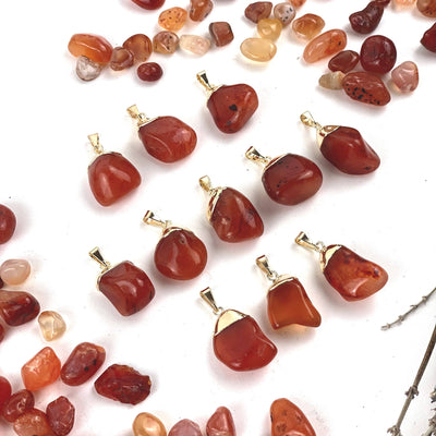 angled shot of 11 Tumbled Carnelian Pendant with Electroplated 24k Gold Caps on white background