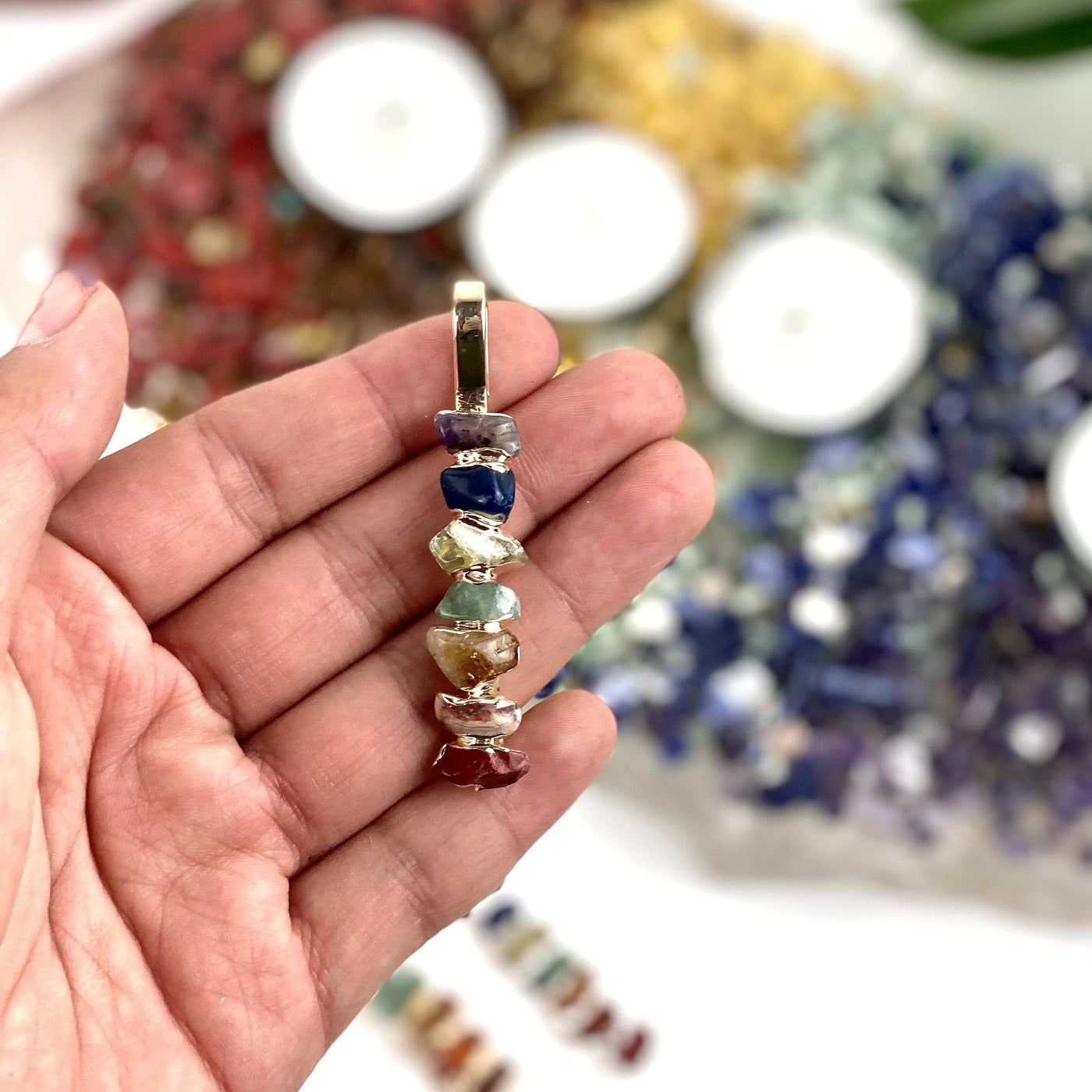 chakra pendant in hand for size reference 