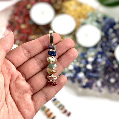 chakra pendant in hand for size reference 