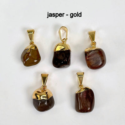 close up of five tumbled jasper pendants in gold for details and possible stone variations