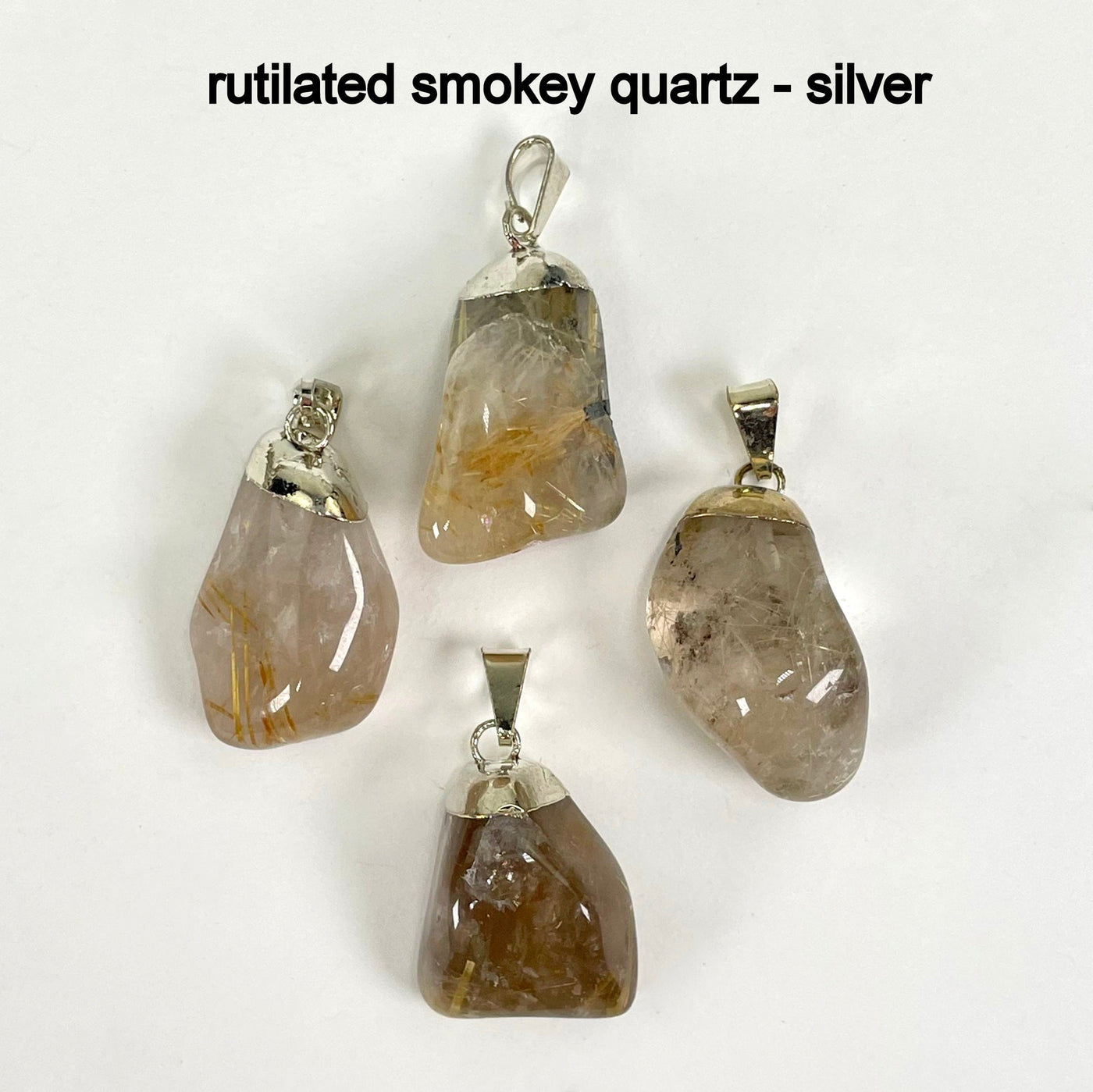 close up of four tumbled rutilated smokey quartz pendants in gold for possible stone variations and details