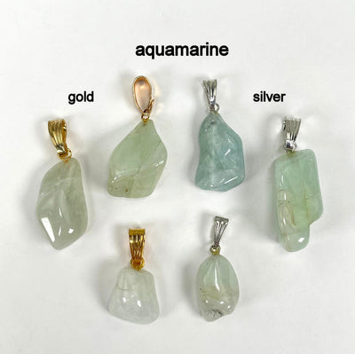 close up of six tumbled aquamarine pendants in gold and silver for possible stone variations, finish comparison, and details