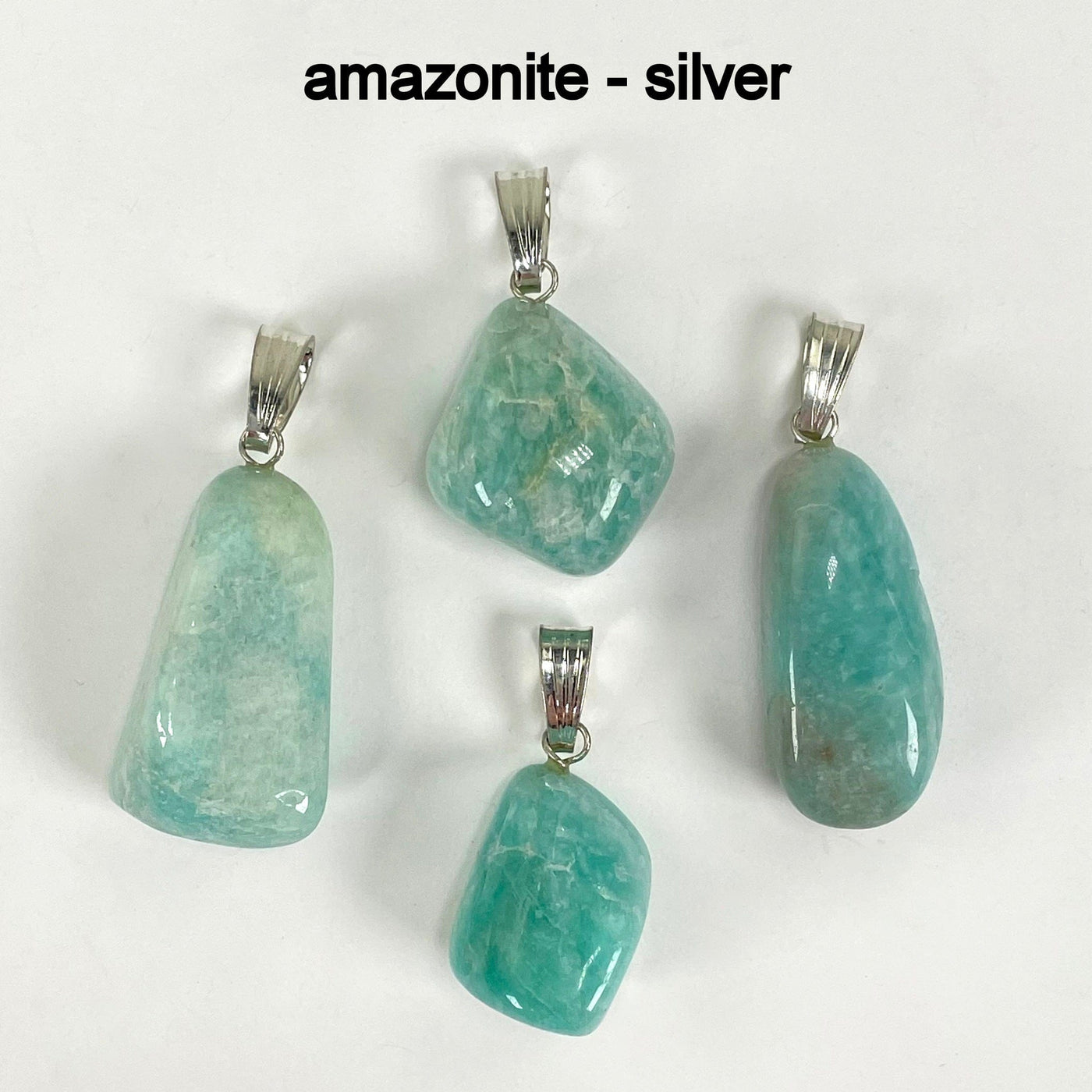 close up of four tumbled amazonite pendants in silver for possible stone variations and details