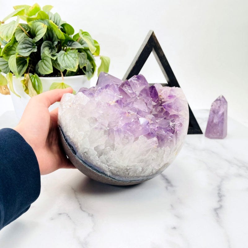 amethyst druzy sphere in hand for size reference