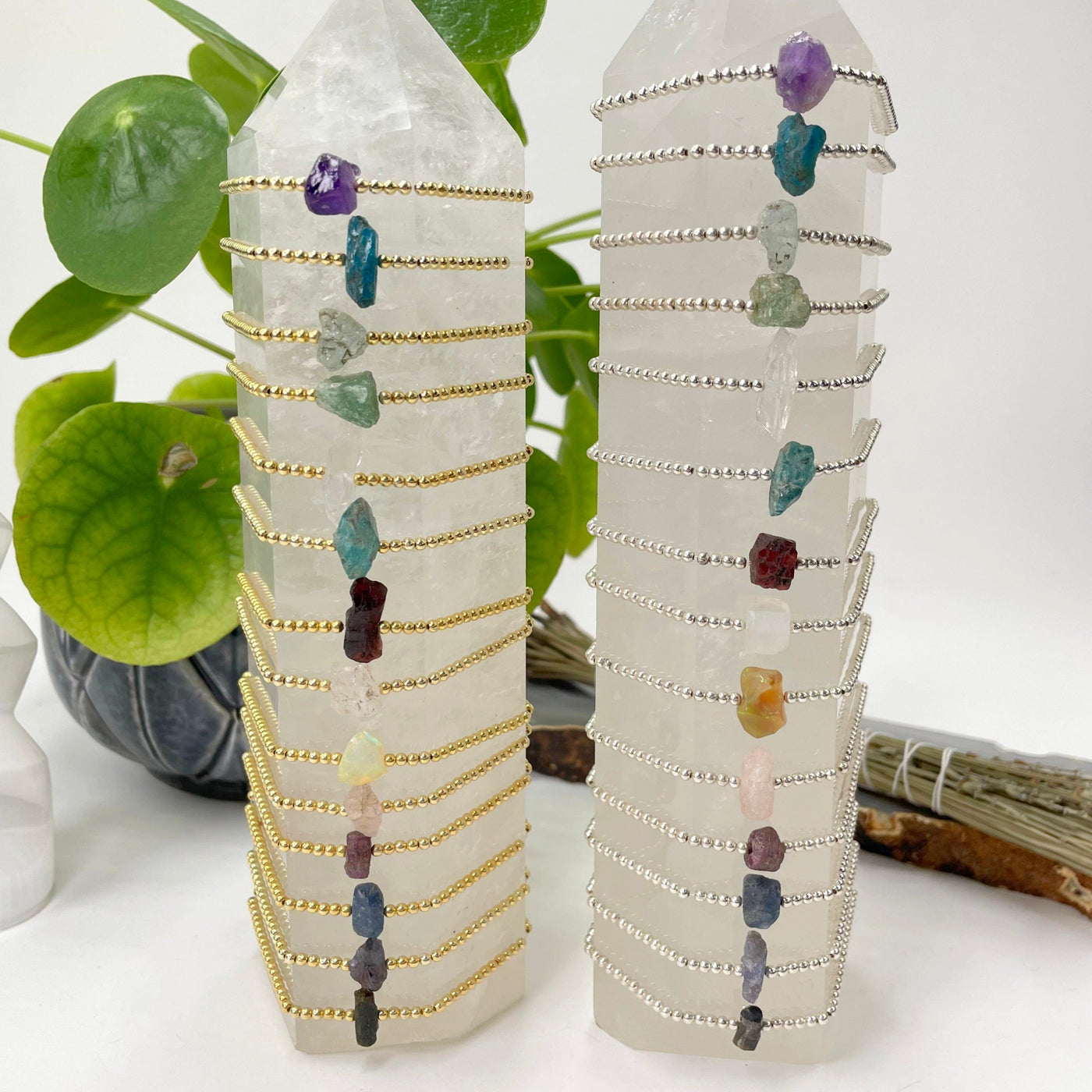 two crystal quartz towers with all gold and silver rough stone bracelet options on display