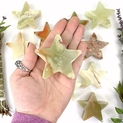 Green Onyx Star displayed in hand for size reference