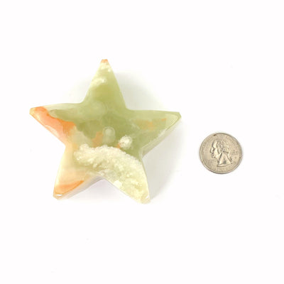 star next to quarter on white background for size reference