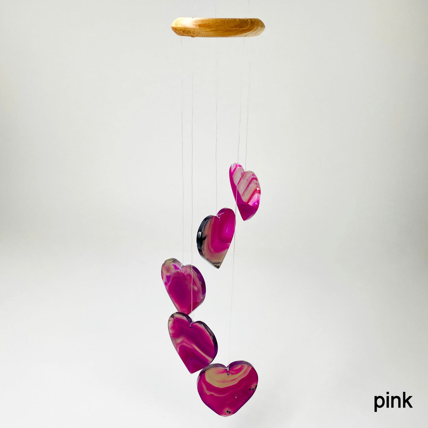one pink agate heart wind chime hanging in front of white background