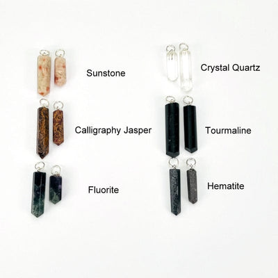 close up of sunstone, calligraphy jasper, fluorite, crystal quartz, black tourmaline and hematite pendants with silver toned bail 