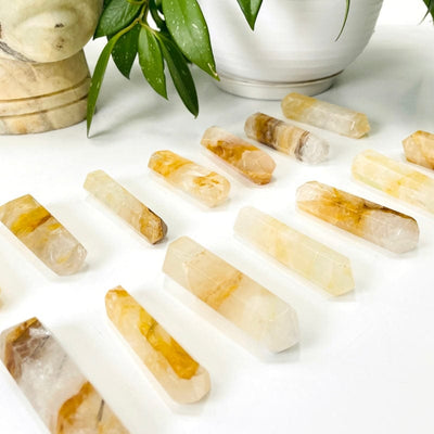 golden healer quartz double terminated points placed in front of backdrop