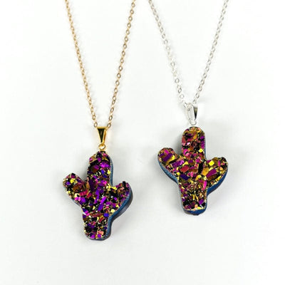 cactus pendants with a rainbow titanium finish displayed with a necklace chain 