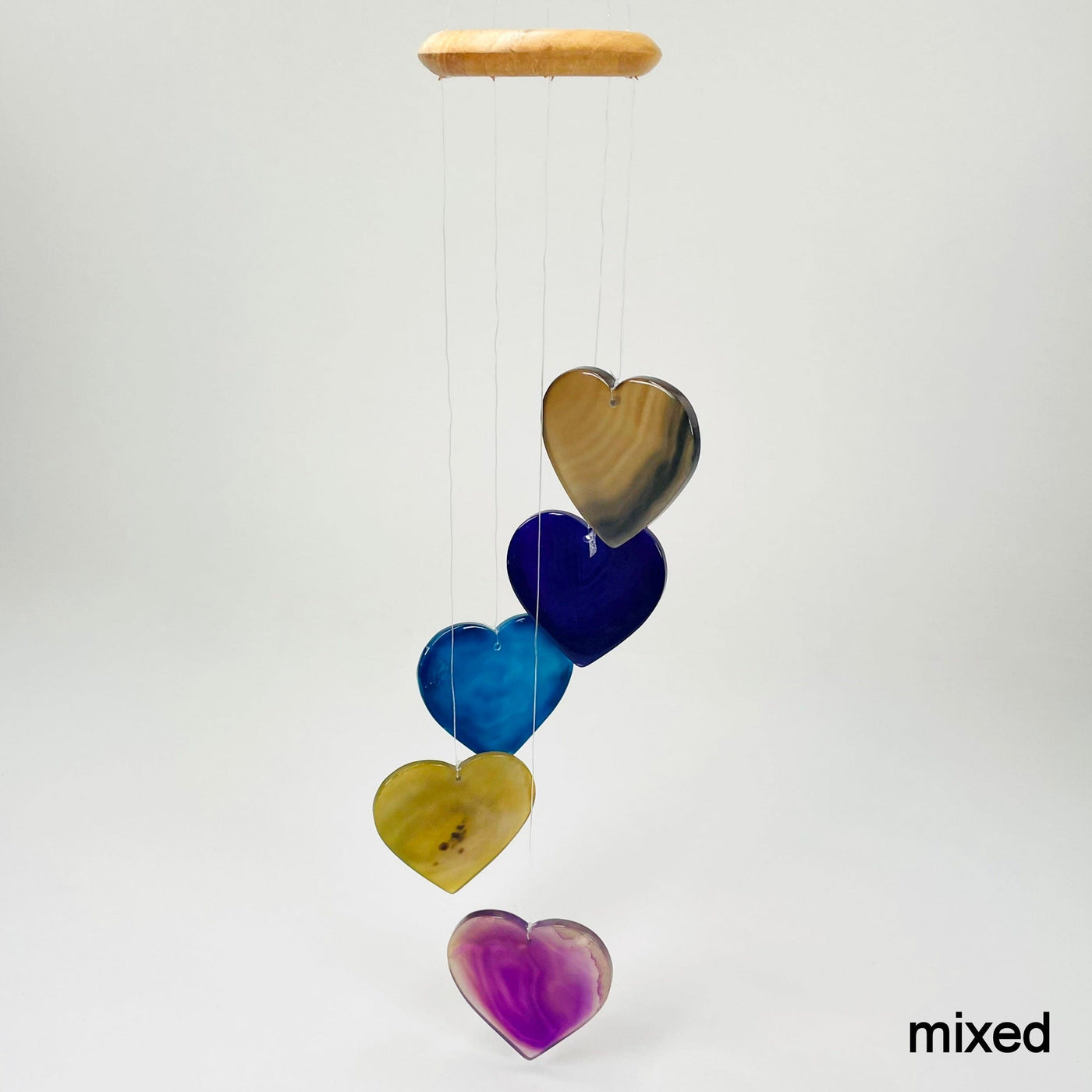 one mixed agate heart wind chime hanging in front of white background