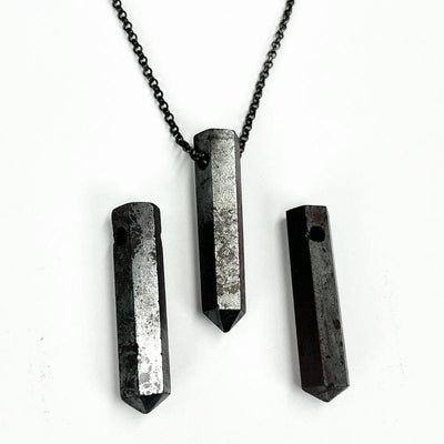 hematite top drilled bead with chain through it to show how it can be used as a necklace