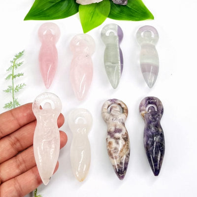 multiple carved gemstone goddesses showing the differences in colors and sizes 