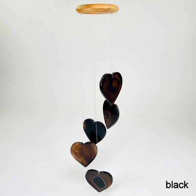 one black agate heart wind chime hanging in front of white background