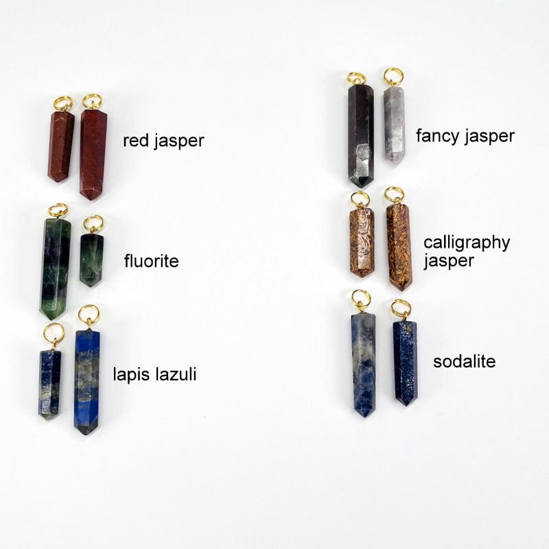 close up of the red jasper, fluorite, lapis lazuli, fancy jasper, calligraphy jasper and sodalite pencil point pendants with gold circle bail 