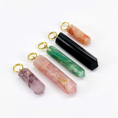 close up of the gemstone pendants with gold circle bails 