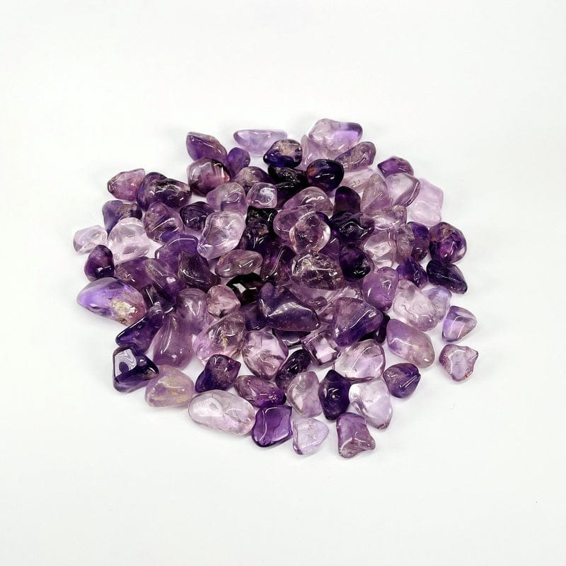 Amethyst tumbled stones on a white background.