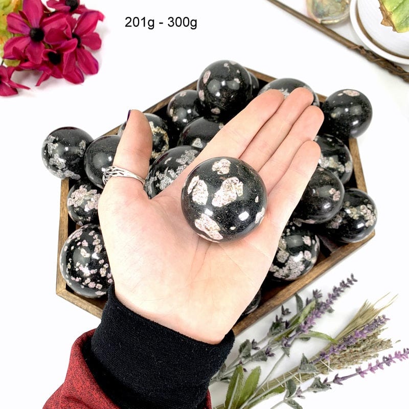 black jade sphere in a hand