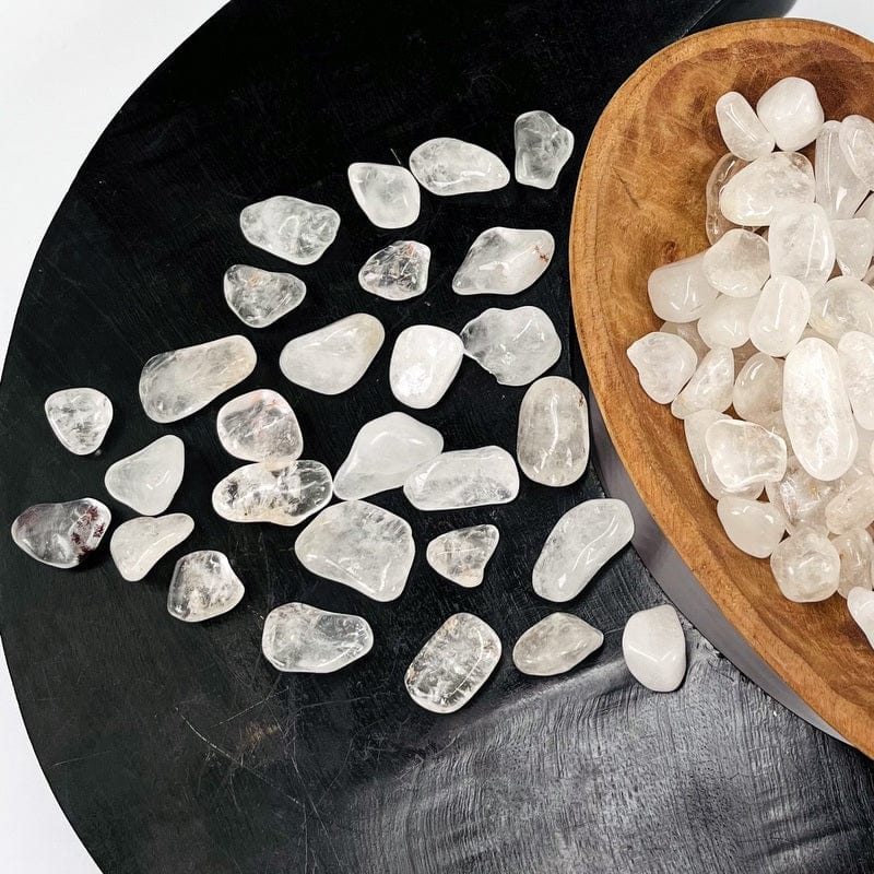 tumbled crystal quartz gemstones displayed to show the differences in sizes 