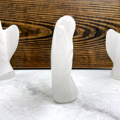 side view of selenite angel statue for thickness