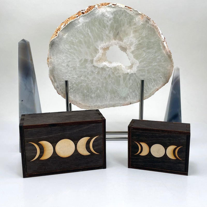 small and large wooden moon phase storage box in front of backdrop