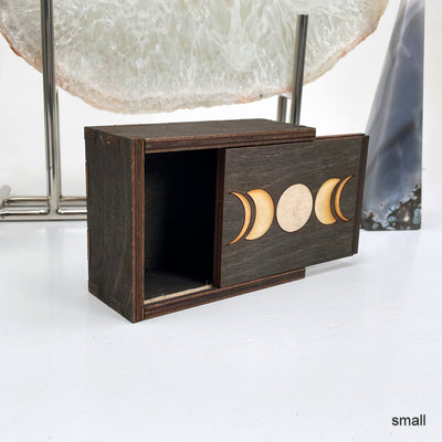 small moon phase wooden storage box propped up and open