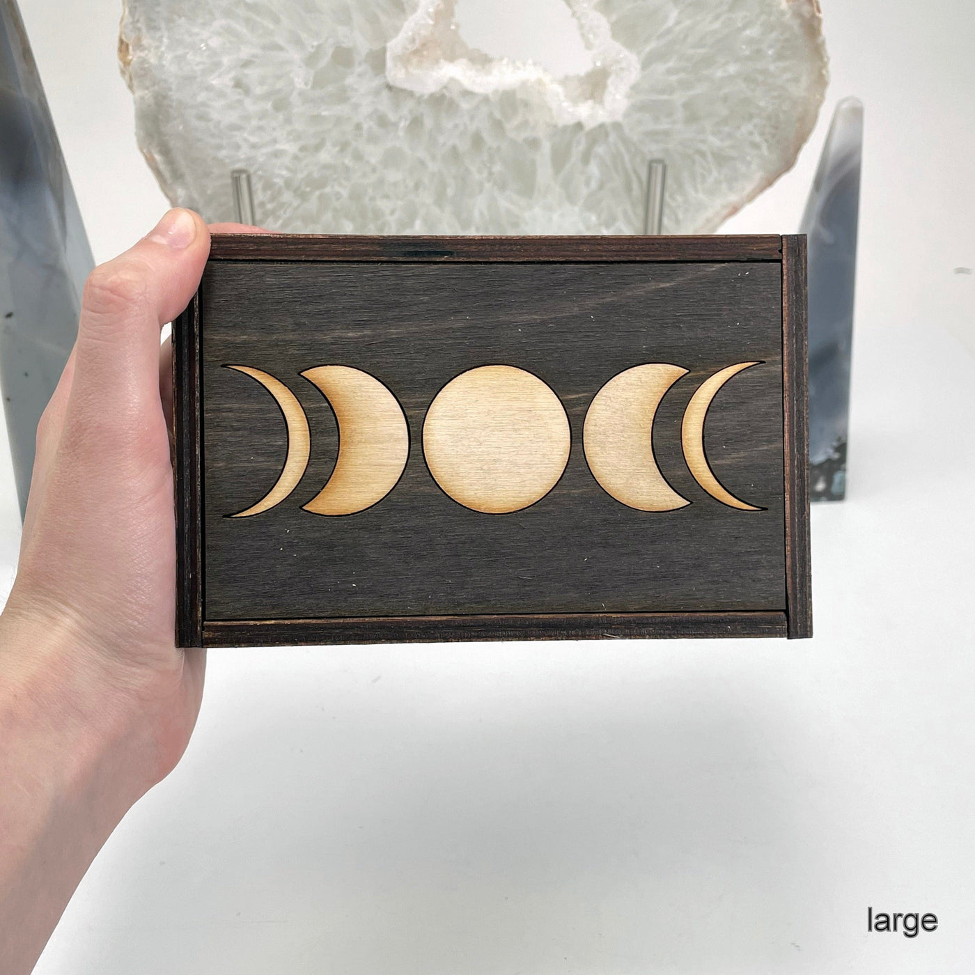 large moon phase wooden storage box in hand for size reference