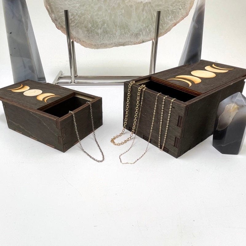 small and large wooden moon phase storage boxes displayed with jewelry