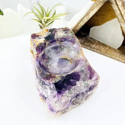 Rainbow Flourite Display Bowl on white table with various decorations in the background