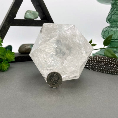 crystal quartz hexagon with quarter for size reference