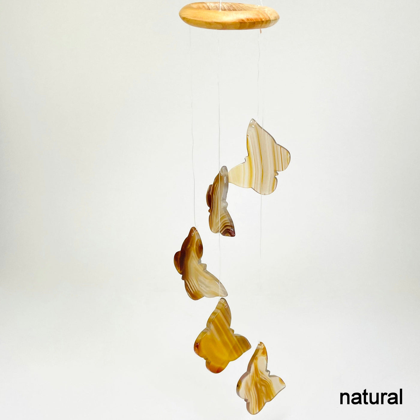 one natural agate butterfly wind chime hanging in front of white background