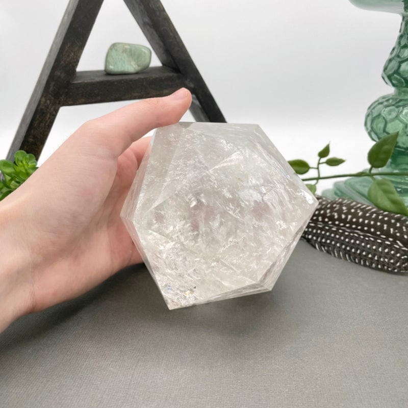 crystal quartz hexagon in hand for size reference