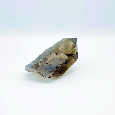 close up of smokey quartz point on white background for details