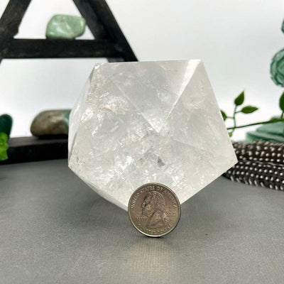 crystal quartz hexagon with quarter for size reference