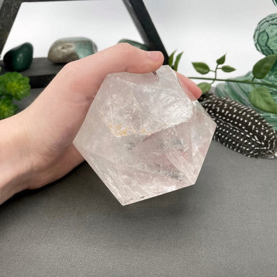 crystal quartz hexagon in hand for size reference