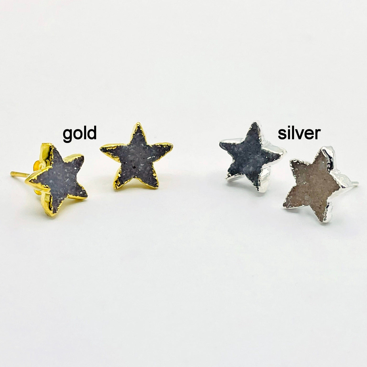 one pair of gold and one pair of silver natural druzy star stud earrings on white background for finish comparison 