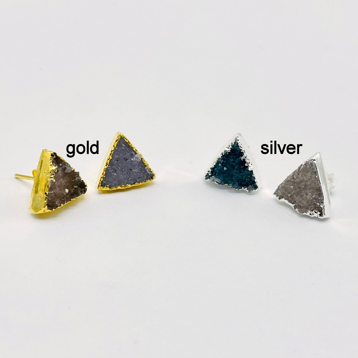 one pair of gold and one pair of silver natural druzy triangle stud earrings on white background for finish comparison