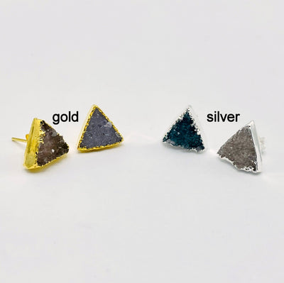 one pair of gold and one pair of silver natural druzy triangle stud earrings on white background for finish comparison